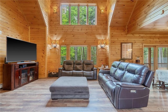 living room featuring high vaulted ceiling, wood walls, wood ceiling, and wood finished floors