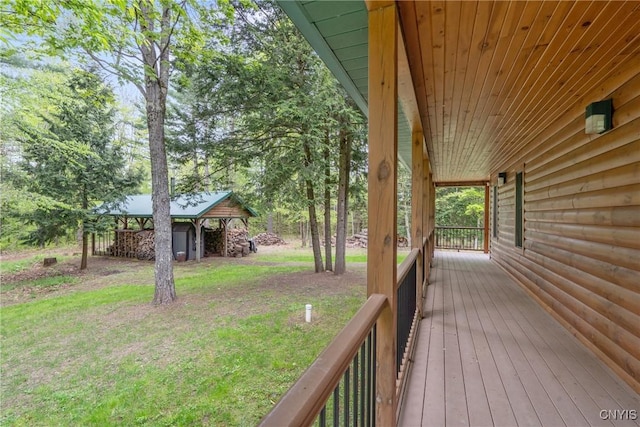 wooden terrace with a lawn