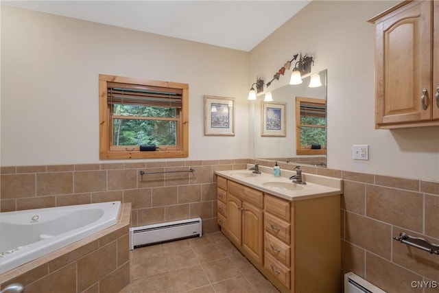 bathroom with a baseboard radiator, tile walls, plenty of natural light, tile patterned flooring, and wainscoting