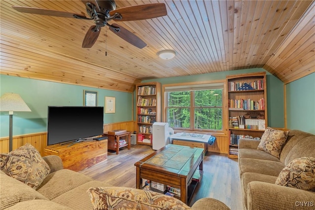 living room featuring wainscoting, lofted ceiling, wooden ceiling, ceiling fan, and wood finished floors
