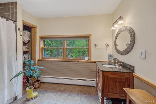 full bath with a baseboard radiator, vanity, wainscoting, and a shower with shower curtain