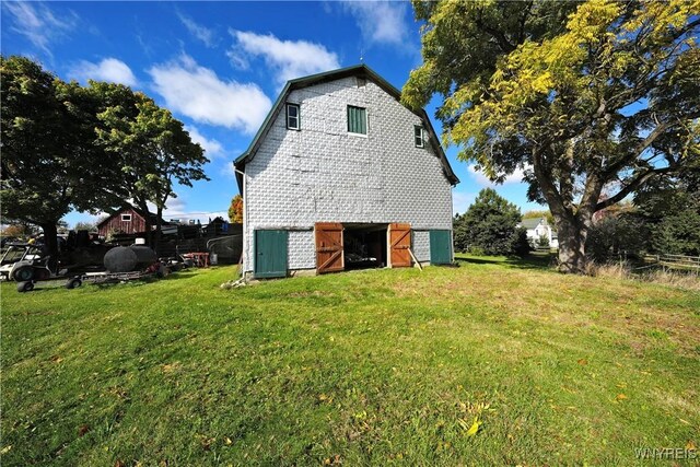 5195 Genesee Rd, North Collins, NY 14141 - view of side of property featuring a barn, a lawn, and an outdoor structure