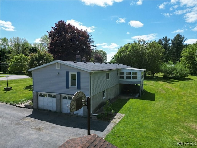 3761 S Main Street Rd, Batavia-Town, NY 14020 - view of front of home with a front lawn, asphalt driveway, and a garage