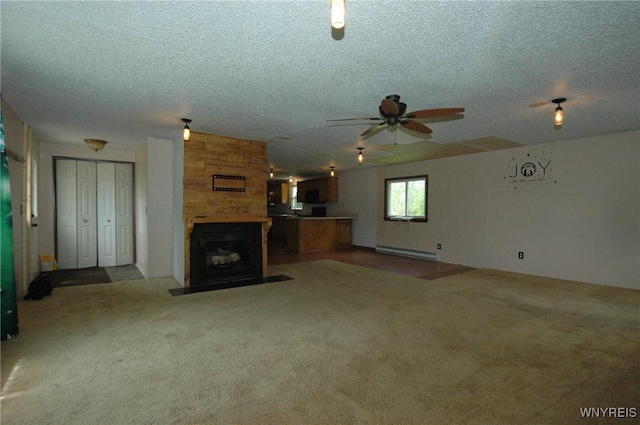 3761 S Main Street Rd, Batavia-Town, NY 14020 - unfurnished living room featuring a baseboard radiator, a ceiling fan, a textured ceiling, a large fireplace, and carpet flooring