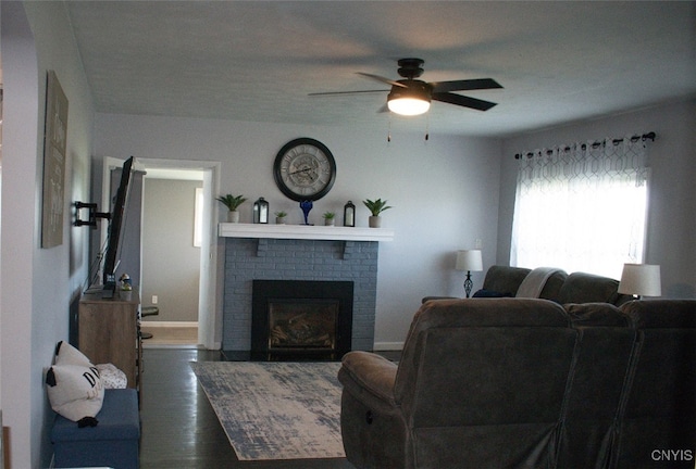 744 State Route 13, Cortlandville, NY 13045 - living area featuring a ceiling fan, wood finished floors, a brick fireplace, and baseboards