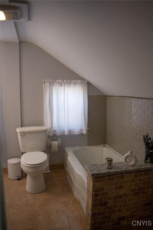 744 State Route 13, Cortlandville, NY 13045 - full bathroom with a bath, tile patterned floors, toilet, and vaulted ceiling