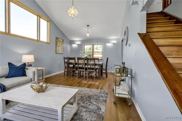 524 Pletcher Rd, Lewiston, NY 14092 - living area with wood finished floors, stairs, vaulted ceiling, and baseboards