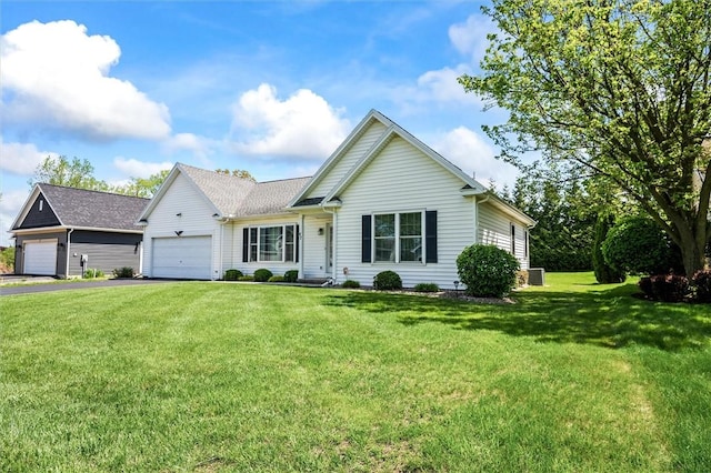 view of front of house with asphalt driveway, a front lawn, and an attached garage