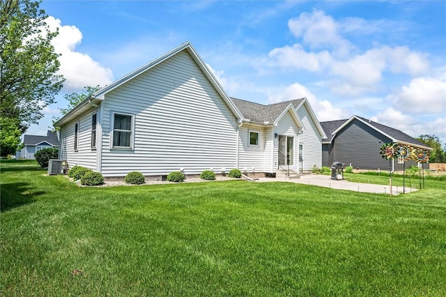 back of property with a patio, a lawn, and central air condition unit