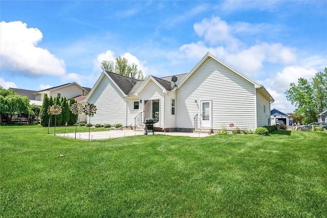 rear view of house featuring a patio area, a lawn, and entry steps