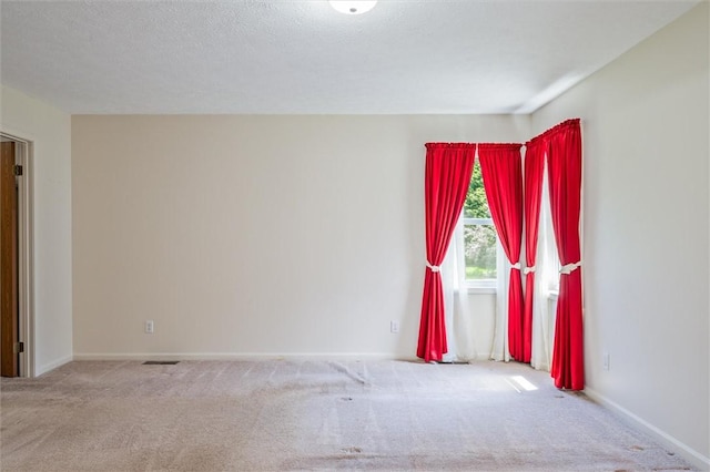 spare room with carpet floors and baseboards