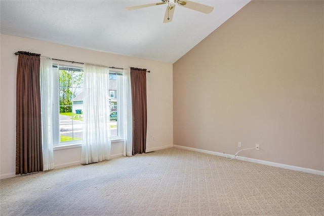unfurnished room featuring carpet floors, a ceiling fan, baseboards, and vaulted ceiling