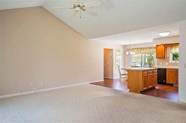 kitchen with dishwasher, dark carpet, brown cabinetry, light countertops, and baseboards