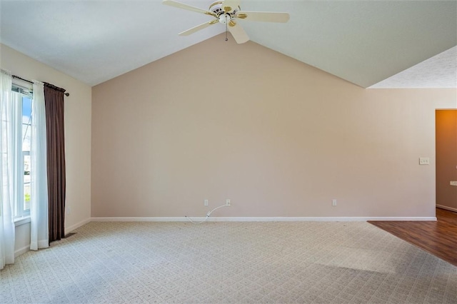 unfurnished room featuring ceiling fan, lofted ceiling, baseboards, and light carpet