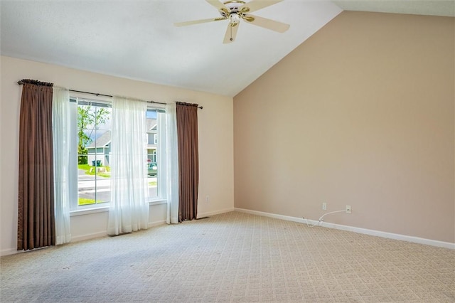 unfurnished room with light carpet, a ceiling fan, vaulted ceiling, and baseboards