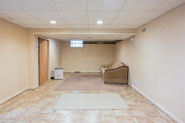 unfurnished room with a paneled ceiling, recessed lighting, and baseboards