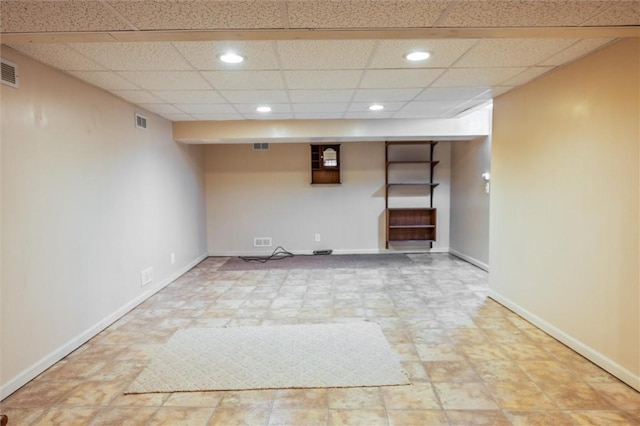 finished below grade area with recessed lighting, a drop ceiling, and baseboards