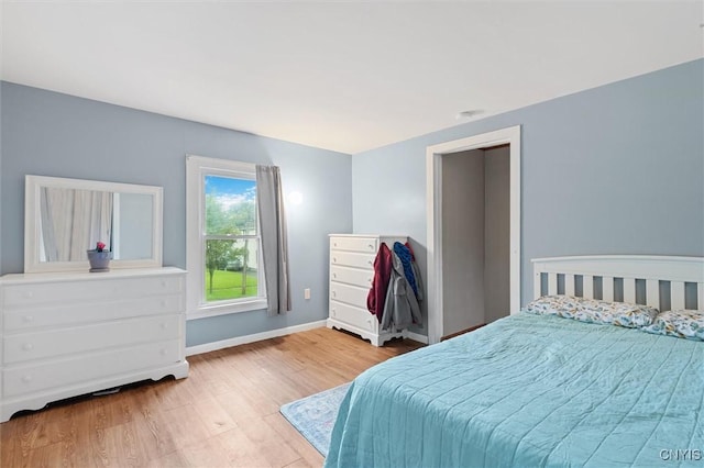 bedroom with wood finished floors and baseboards