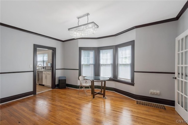944 Bellevue Ave, Syracuse, NY 13204 - spare room featuring ornamental molding, hardwood / wood-style floors, baseboards, a chandelier, and a sink