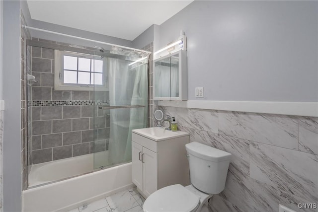 944 Bellevue Ave, Syracuse, NY 13204 - full bathroom featuring toilet, bath / shower combo with glass door, tile walls, vanity, and marble finish flooring