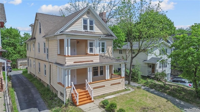 944 Bellevue Ave, Syracuse, NY 13204 - view of front of house featuring a porch, a chimney, and roof with shingles
