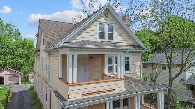 944 Bellevue Ave, Syracuse, NY 13204 - view of front of home with a chimney, roof with shingles, and an outbuilding