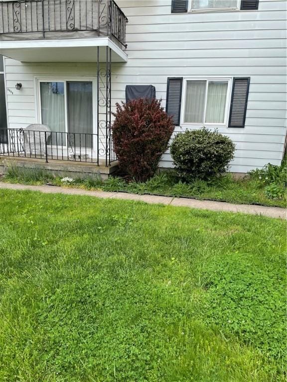 6088 Brockport Spencerport Rd Unit 2, Sweden, NY 14420 - view of exterior entry with a balcony and a yard