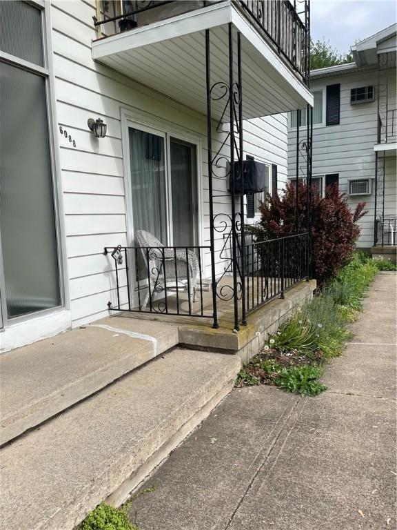 6088 Brockport Spencerport Rd Unit 2, Sweden, NY 14420 - view of exterior entry with a balcony and covered porch