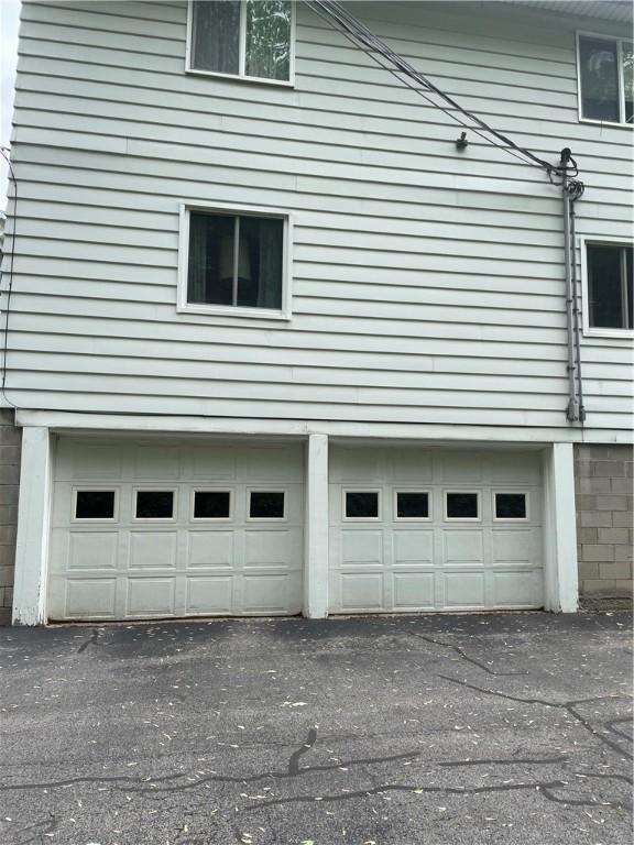 6088 Brockport Spencerport Rd Unit 2, Sweden, NY 14420 - view of side of property featuring an attached garage and asphalt driveway