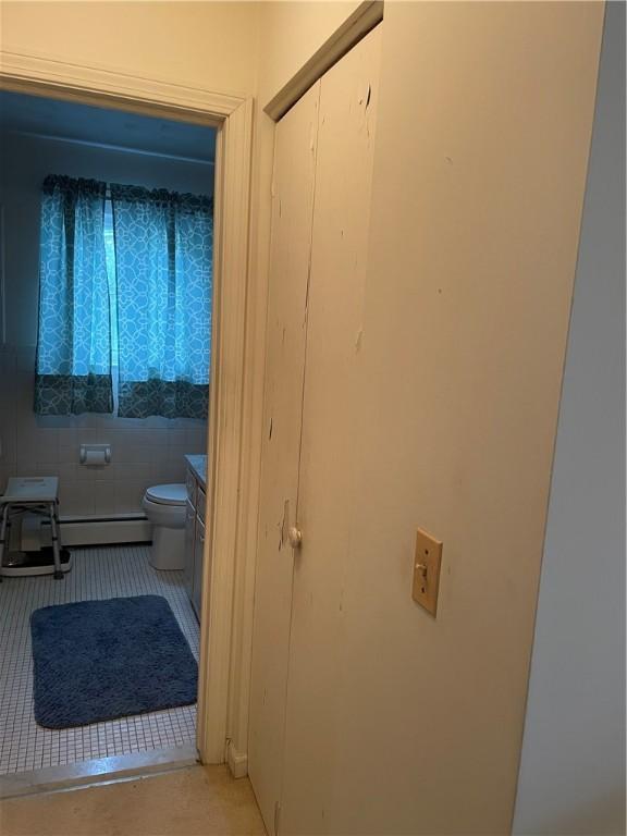 6088 Brockport Spencerport Rd Unit 2, Sweden, NY 14420 - bathroom with tile patterned flooring, toilet, and a baseboard heating unit