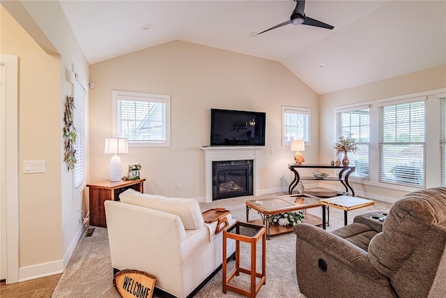 225 Cos Grande, Brighton, NY 14618 - living room with a glass covered fireplace, a ceiling fan, lofted ceiling, baseboards, and light colored carpet