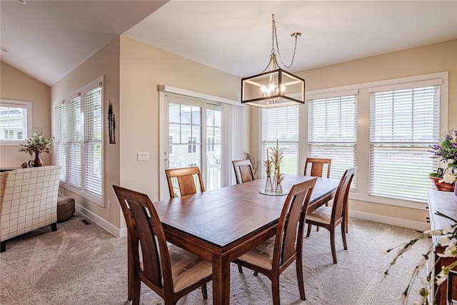 225 Cos Grande, Brighton, NY 14618 - dining room with light carpet, a chandelier, baseboards, and lofted ceiling