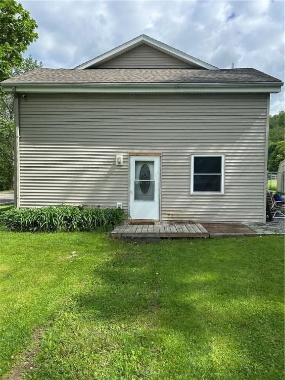 4228 Main St, Veteran, NY 14864 - rear view of house featuring a lawn, a shingled roof, and a deck