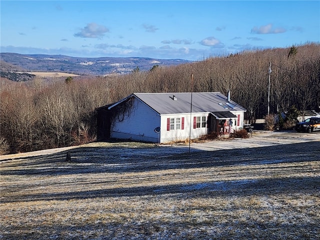 178 Dunshee Rd, Sidney, NY 13849 - view of front facade with a wooded view and metal roof