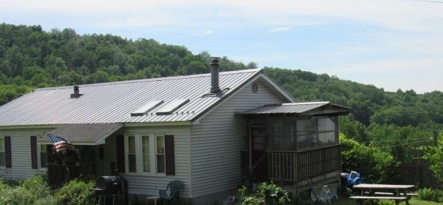 178 Dunshee Rd, Sidney, NY 13849 - view of side of property with a wooded view, metal roof, and a standing seam roof