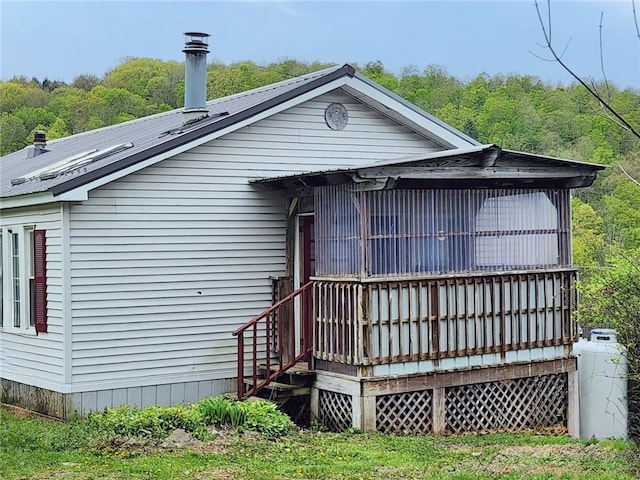 178 Dunshee Rd, Sidney, NY 13849 - rear view of property with a metal roof, a wooden deck, and a wooded view