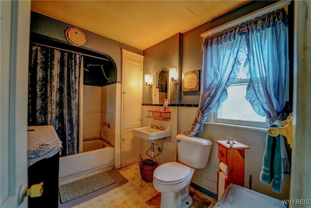 72 W 5th St, Dunkirk-City, NY 14048 - full bath with toilet, tile patterned floors, shower / bathtub combination with curtain, tile walls, and a wainscoted wall