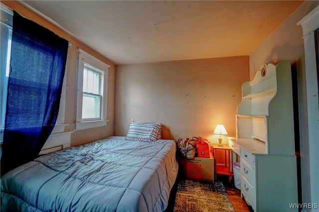 72 W 5th St, Dunkirk-City, NY 14048 - bedroom featuring wood finished floors and a baseboard radiator
