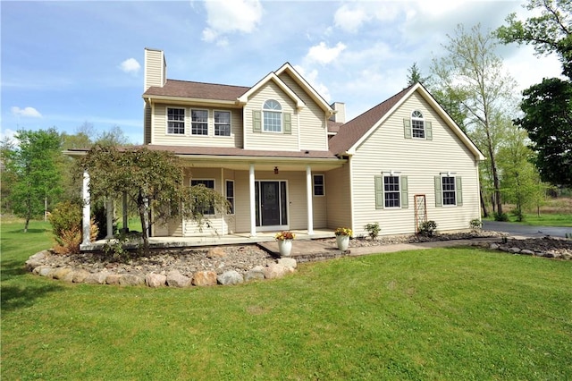90 Davenport Rd, Big Flats, NY 14814 - view of front of property with a chimney, a front lawn, and covered porch