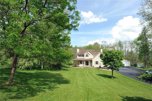 90 Davenport Rd, Big Flats, NY 14814 - view of front of home with a detached garage, a front yard, covered porch, and a chimney