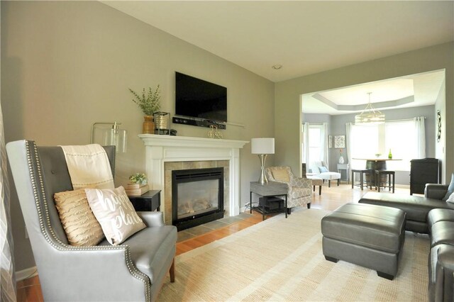 90 Davenport Rd, Big Flats, NY 14814 - living room with a tile fireplace, wood finished floors, and a tray ceiling