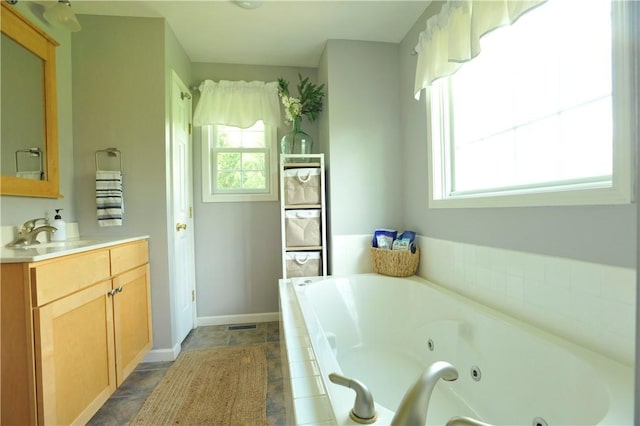 90 Davenport Rd, Big Flats, NY 14814 - full bathroom with a tub with jets, vanity, and baseboards