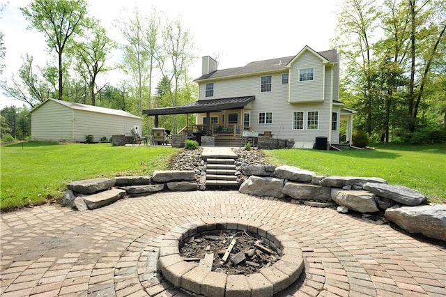 90 Davenport Rd, Big Flats, NY 14814 - back of house featuring a fire pit, a patio, a yard, a chimney, and central AC unit