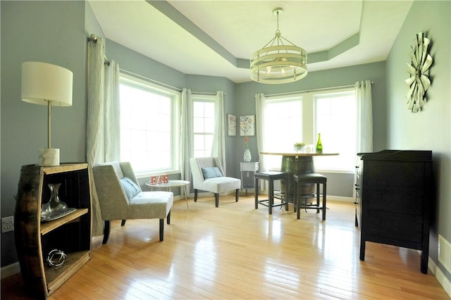 90 Davenport Rd, Big Flats, NY 14814 - living area featuring a raised ceiling, a chandelier, hardwood / wood-style flooring, and baseboards