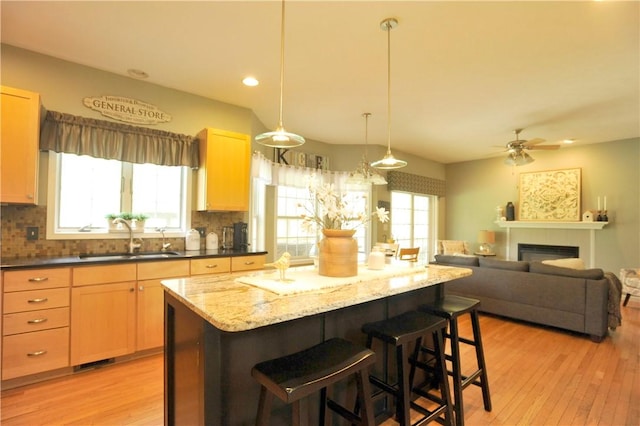 90 Davenport Rd, Big Flats, NY 14814 - kitchen with a sink, a breakfast bar area, light wood-style floors, decorative backsplash, and recessed lighting