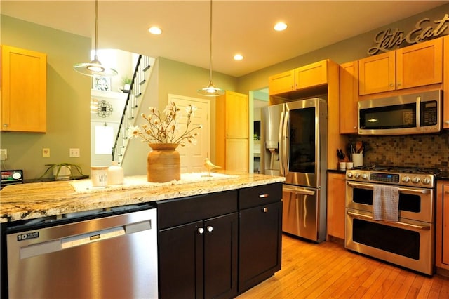 90 Davenport Rd, Big Flats, NY 14814 - kitchen featuring appliances with stainless steel finishes, light wood finished floors, decorative backsplash, light stone counters, and recessed lighting