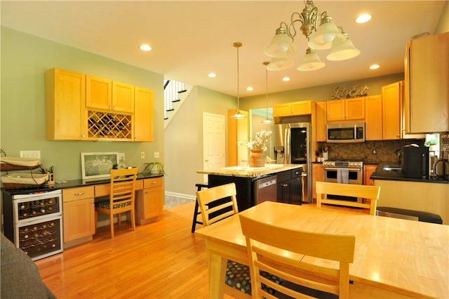 90 Davenport Rd, Big Flats, NY 14814 - kitchen with stainless steel appliances, light brown cabinets, light wood-style floors, backsplash, and decorative light fixtures