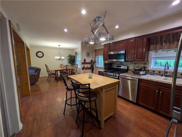 1405 W Main St, Smethport-Borough, PA 16749 - kitchen with appliances with stainless steel finishes, butcher block counters, a sink, a kitchen breakfast bar, and tasteful backsplash