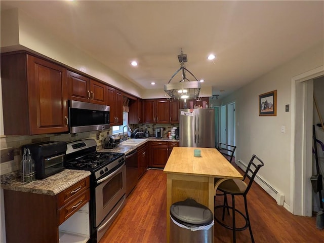 1405 W Main St, Smethport-Borough, PA 16749 - kitchen featuring appliances with stainless steel finishes, butcher block counters, a baseboard radiator, wood finished floors, and a sink