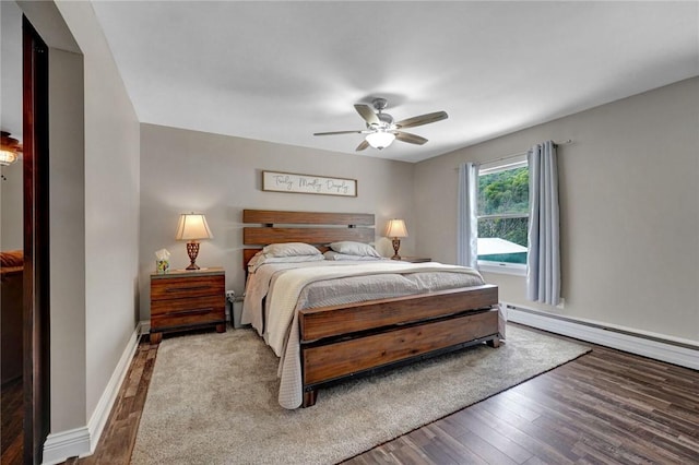 557 Interstate Pkwy, Foster-Town, PA 16701 - bedroom featuring wood finished floors, baseboards, a ceiling fan, and a baseboard heating unit